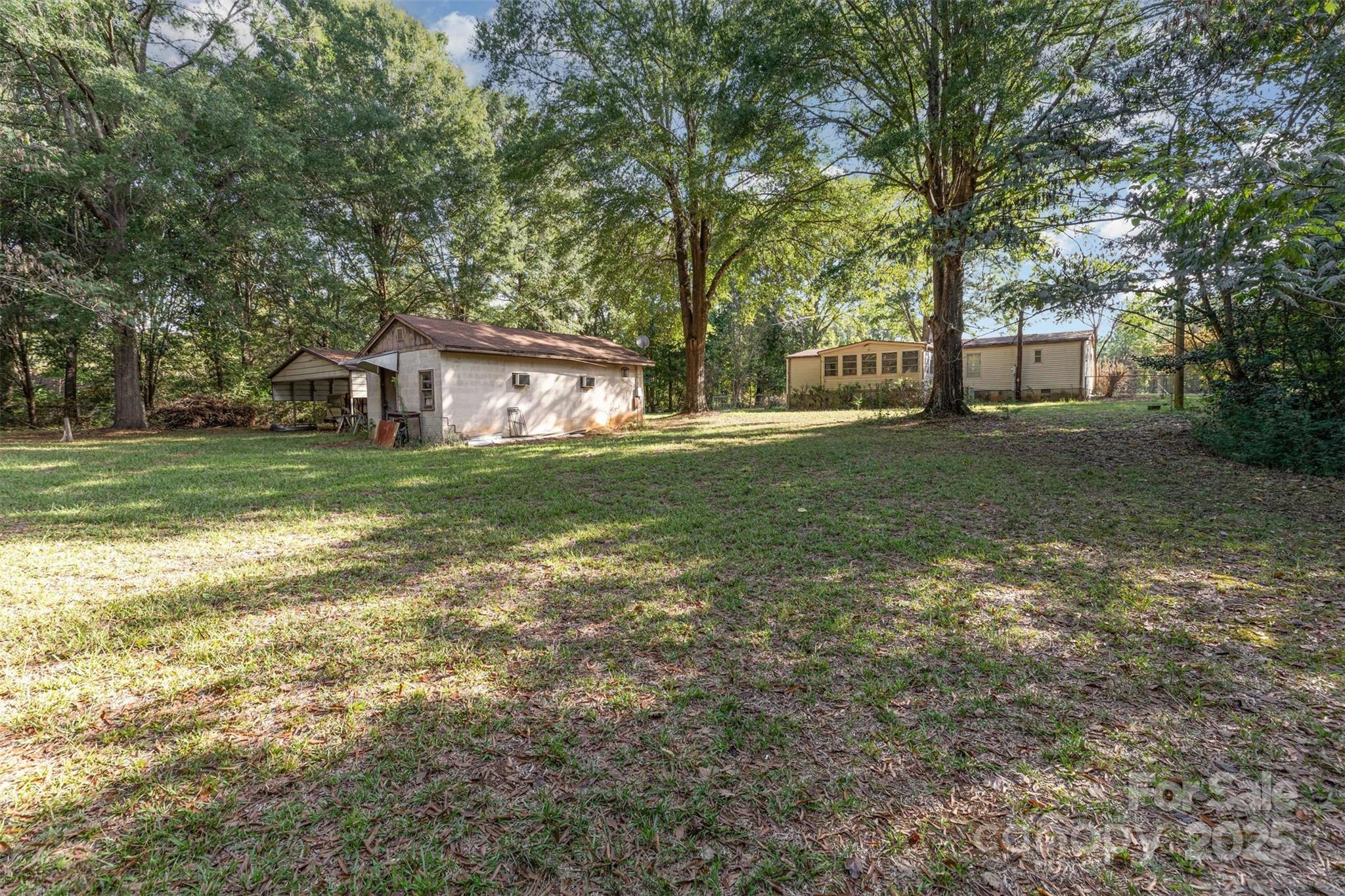 11500 Beagle Street Midland, NC 28107 - Photo 11 of 15 a view of a house with a big yard and large trees