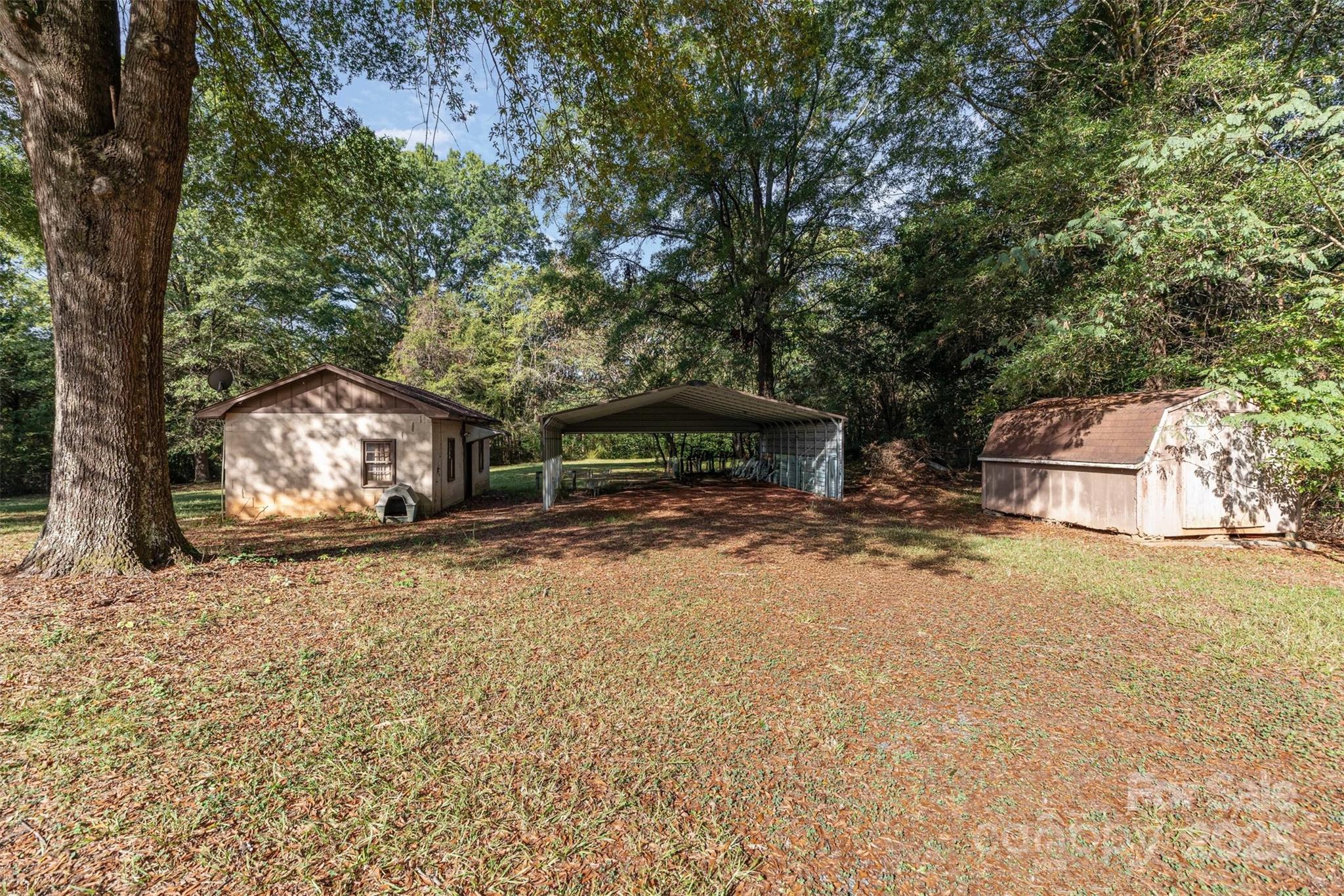 11500 Beagle Street Midland, NC 28107 - Photo 8 of 15 a backyard of a house with fire pit and outdoor seating