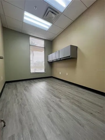 a view of room with window and wooden floor
