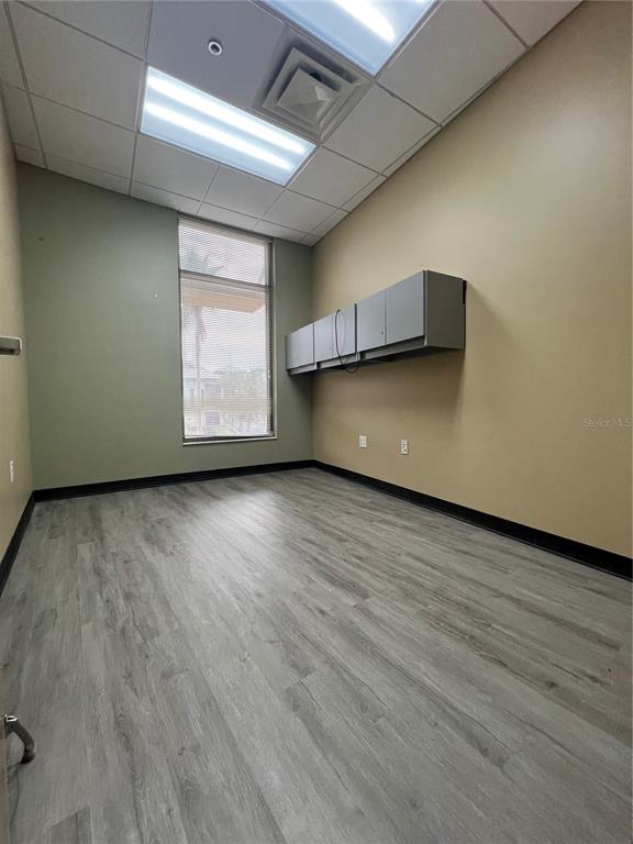 a view of room with window and wooden floor