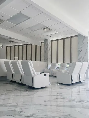 a living room with furniture and large windows