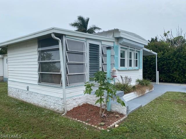 137 Rookery Road Naples, FL 34114 - Photo 20 of 23 a front view of house with yard