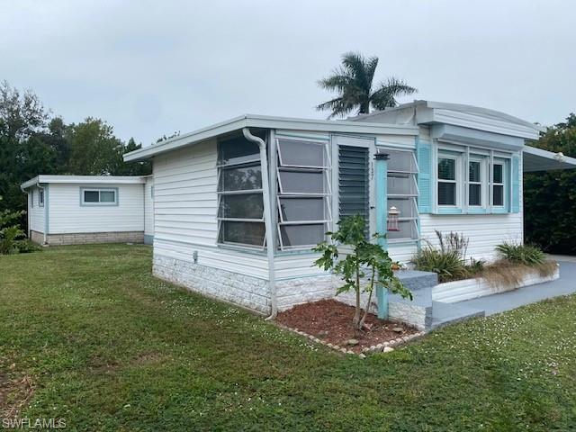 137 Rookery Road Naples, FL 34114 - Photo 21 of 23 a front view of a house with a yard and garage