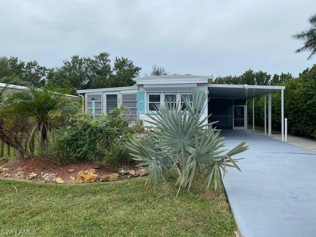 137 Rookery Road Naples, FL 34114 - Photo 22 of 23 a front view of house with yard and green space