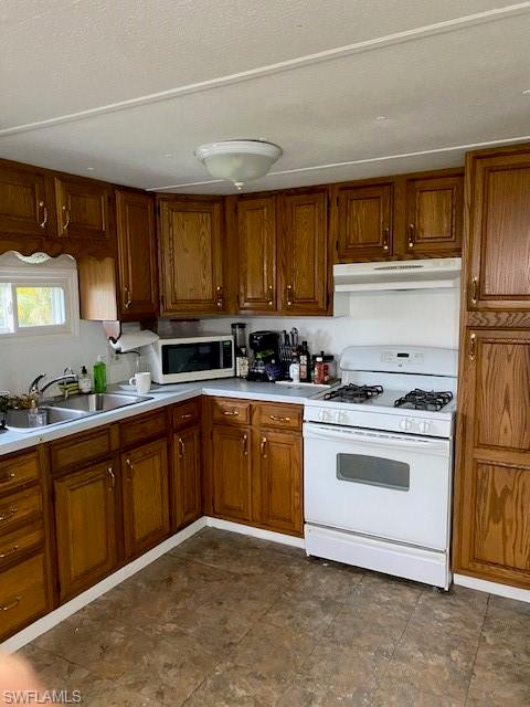 137 Rookery Road Naples, FL 34114 - Photo 9 of 23 a kitchen with granite countertop a sink stainless steel appliances and cabinets