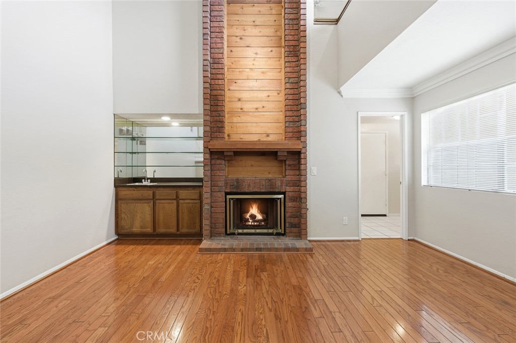 919 Auburn Road San Dimas, CA 91773 - Photo 9 of 52 Livingroom, fireplace and wet bar. Door on the right is to half bath and garage