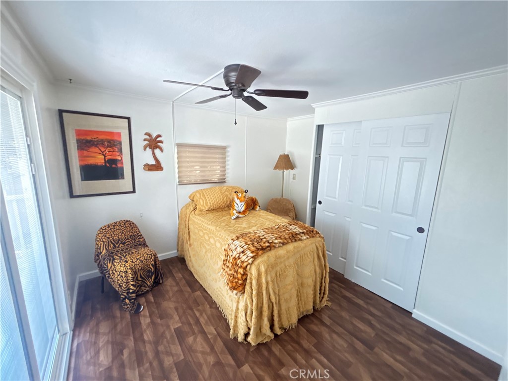 31130 South General Kearny Road, Unit 172 Temecula, CA 92591 - Photo 19 of 49 Bedroom with barn door and large sliding door with custom installed blinds in back glass