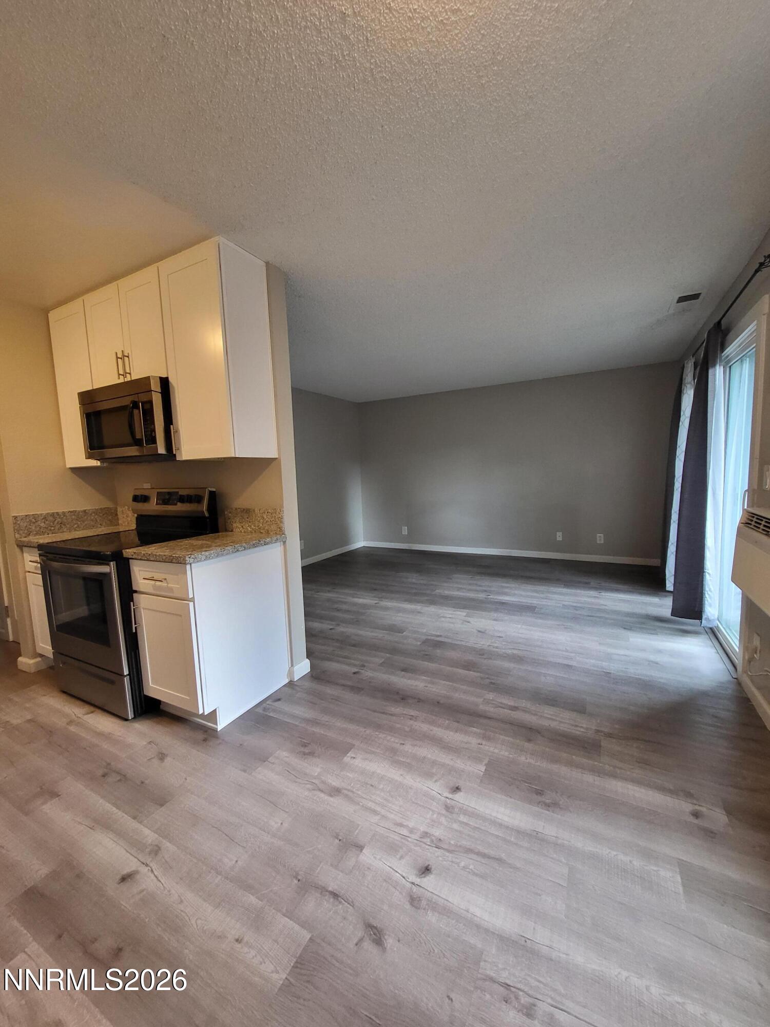 4606 Neil Road, Unit 197 Reno, NV 89502 - Photo 23 of 26 a view of kitchen with microwave and cabinets