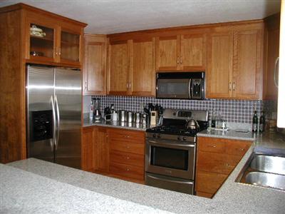 4352 Goodson Way Rohnert Park, CA 94928 - Photo 3 of 9 a kitchen with granite countertop a stove top oven microwave and cabinets