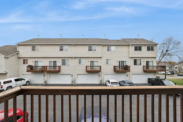 a view of a street with cars parked in front of it