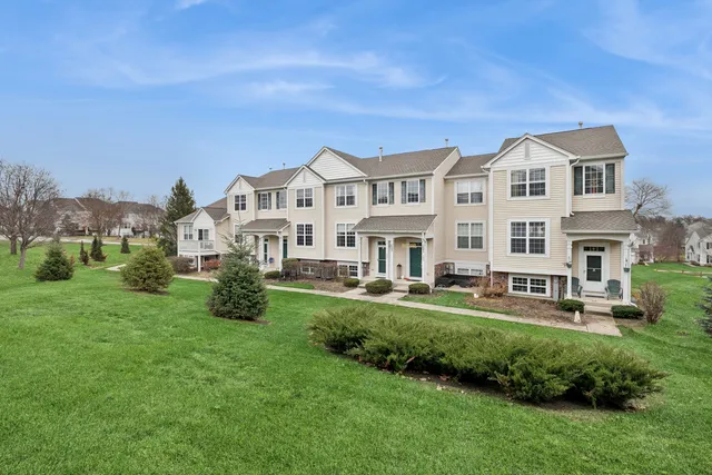 a front view of a house with a yard table and chairs