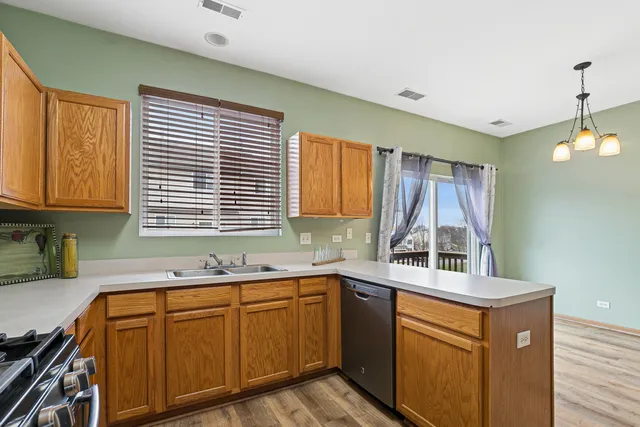 a kitchen with a sink cabinets and window