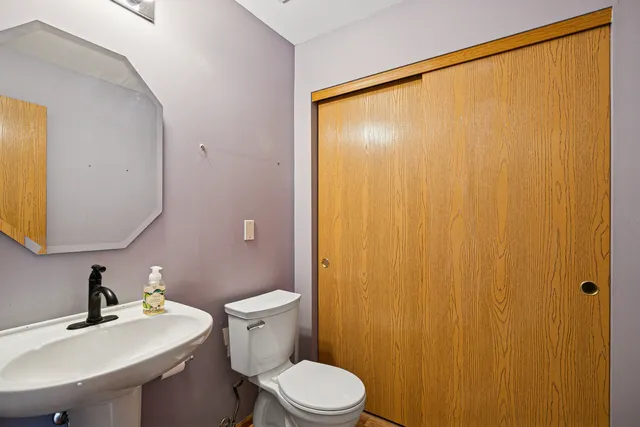 a bathroom with a sink a toilet and mirror