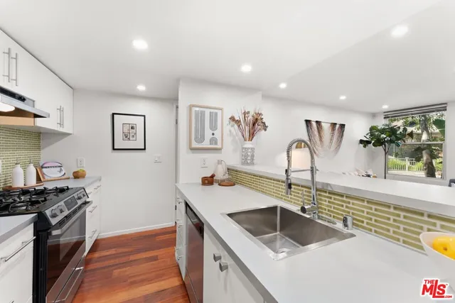 a kitchen with a sink and a stove top oven