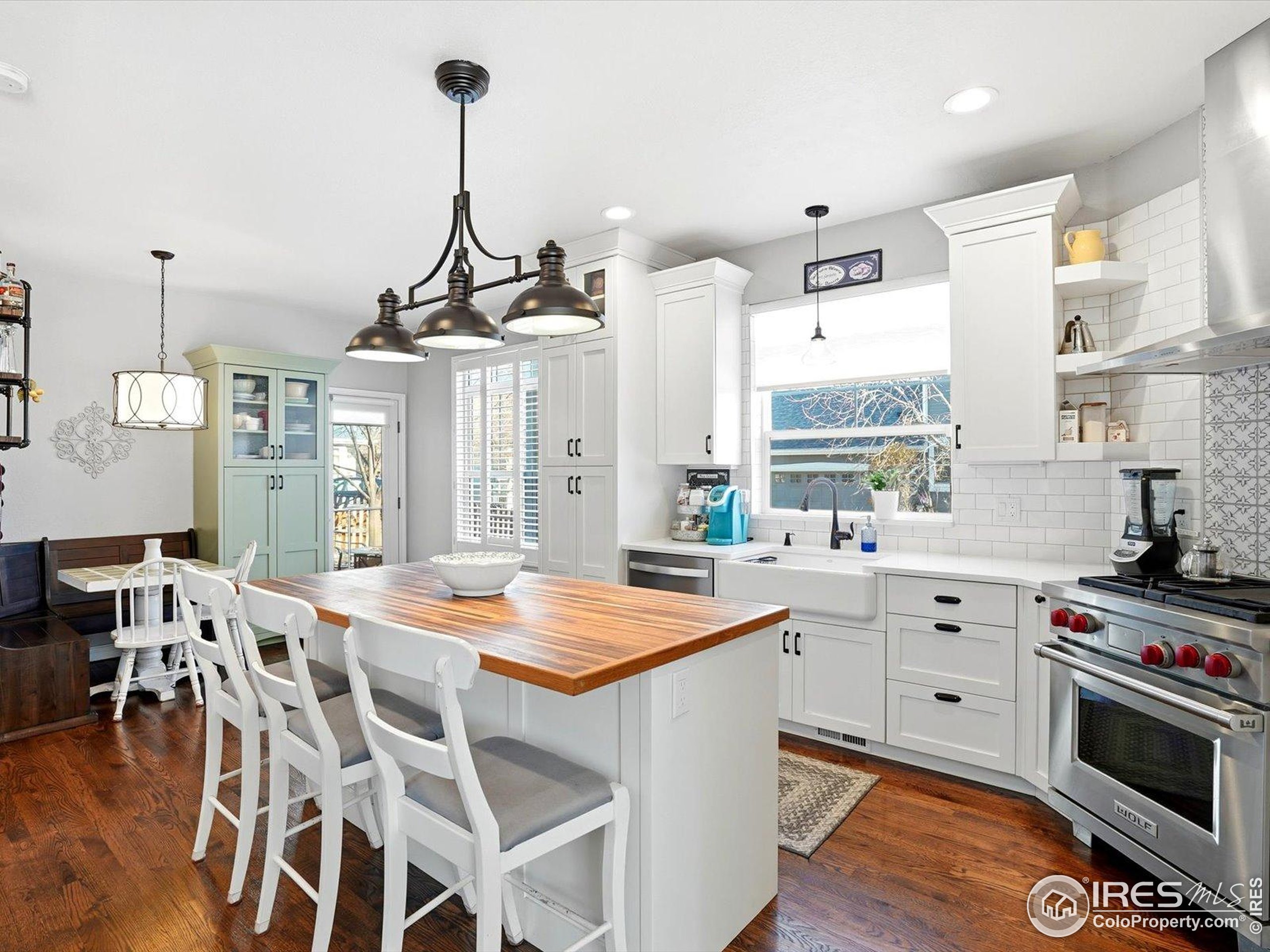 2139 Springs Place Longmont, CO 80504 - Photo 13 of 50 a kitchen with stainless steel appliances kitchen island granite countertop a stove a sink and a refrigerator
