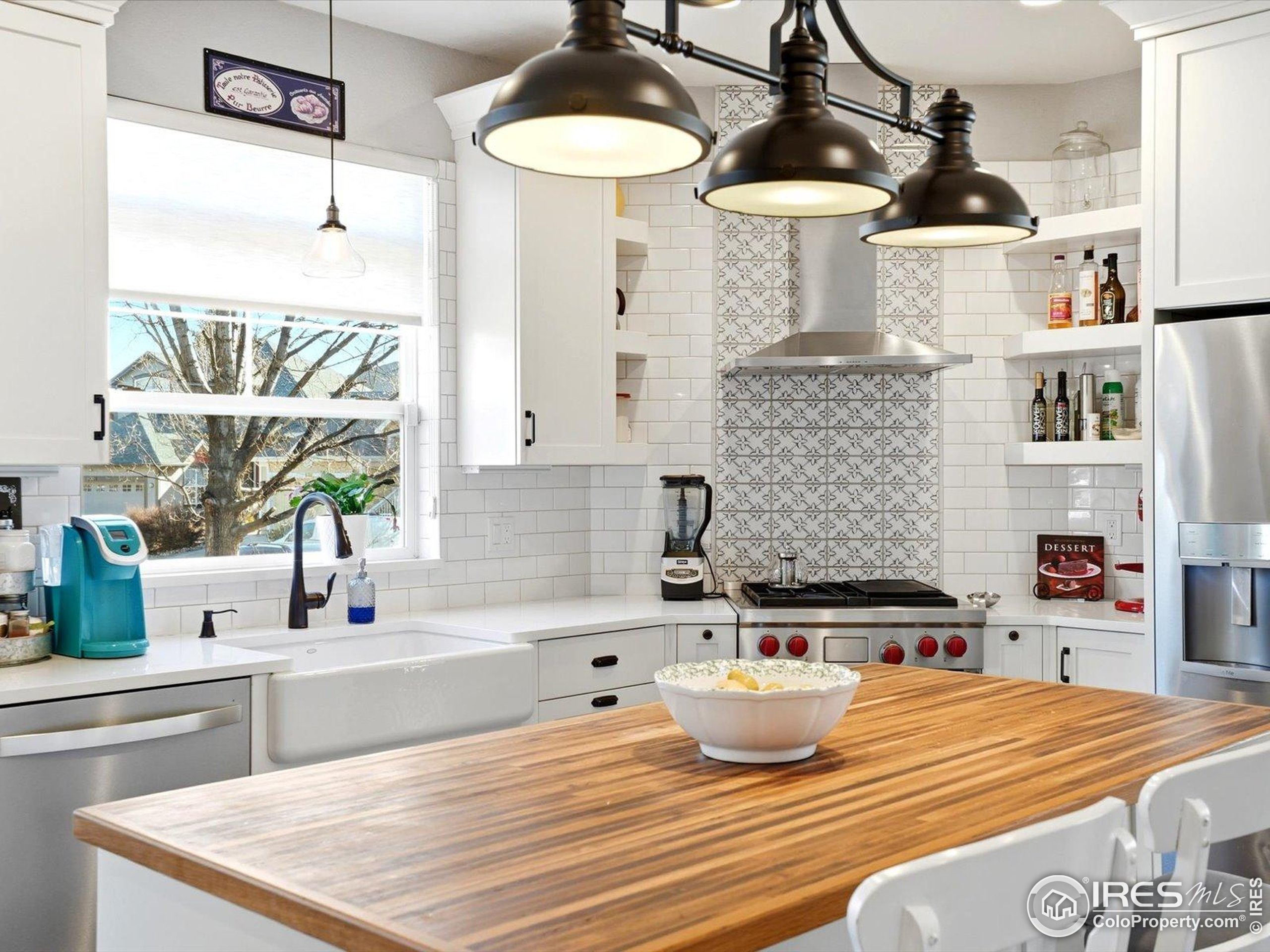 2139 Springs Place Longmont, CO 80504 - Photo 15 of 50 a kitchen with a sink a stove and cabinets