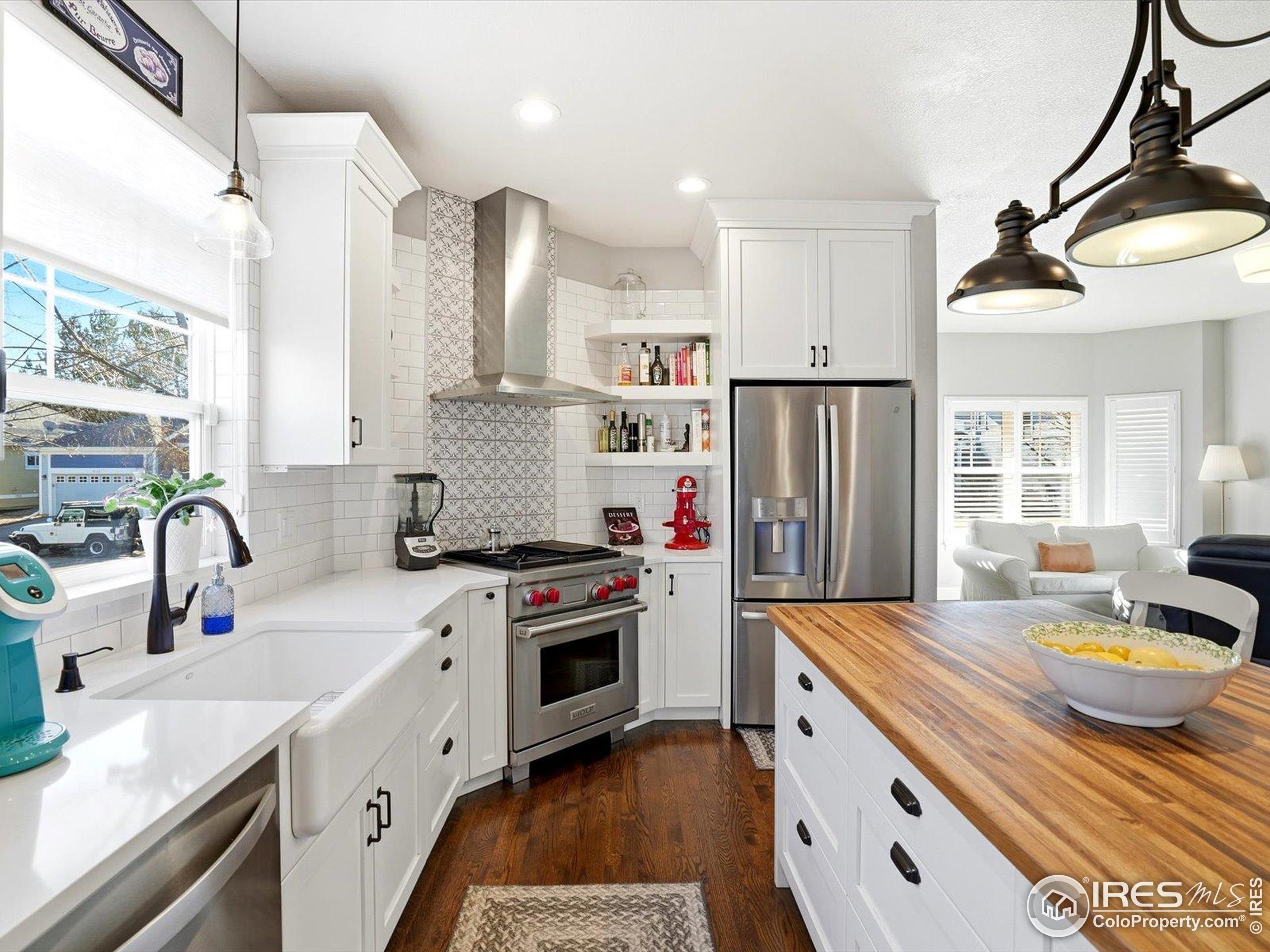 2139 Springs Place Longmont, CO 80504 - Photo 16 of 50 a kitchen with stainless steel appliances granite countertop a sink stove and refrigerator