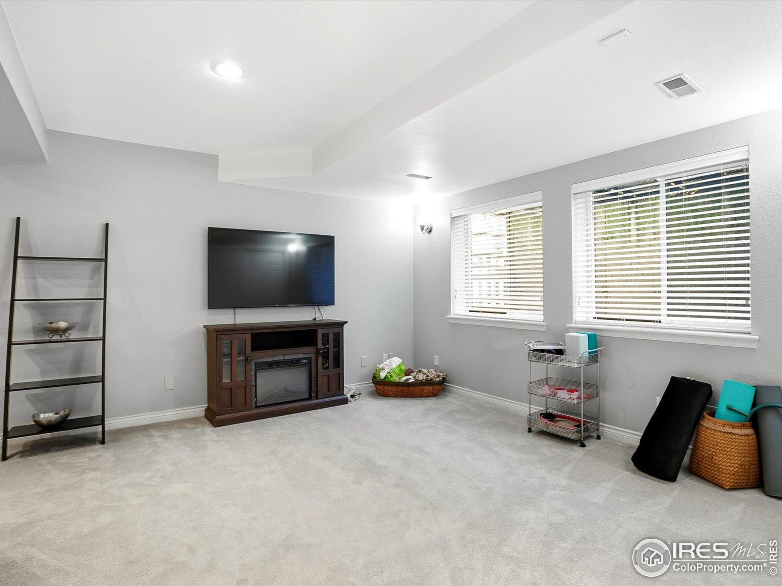 2139 Springs Place Longmont, CO 80504 - Photo 24 of 50 a living room with furniture and a flat screen tv