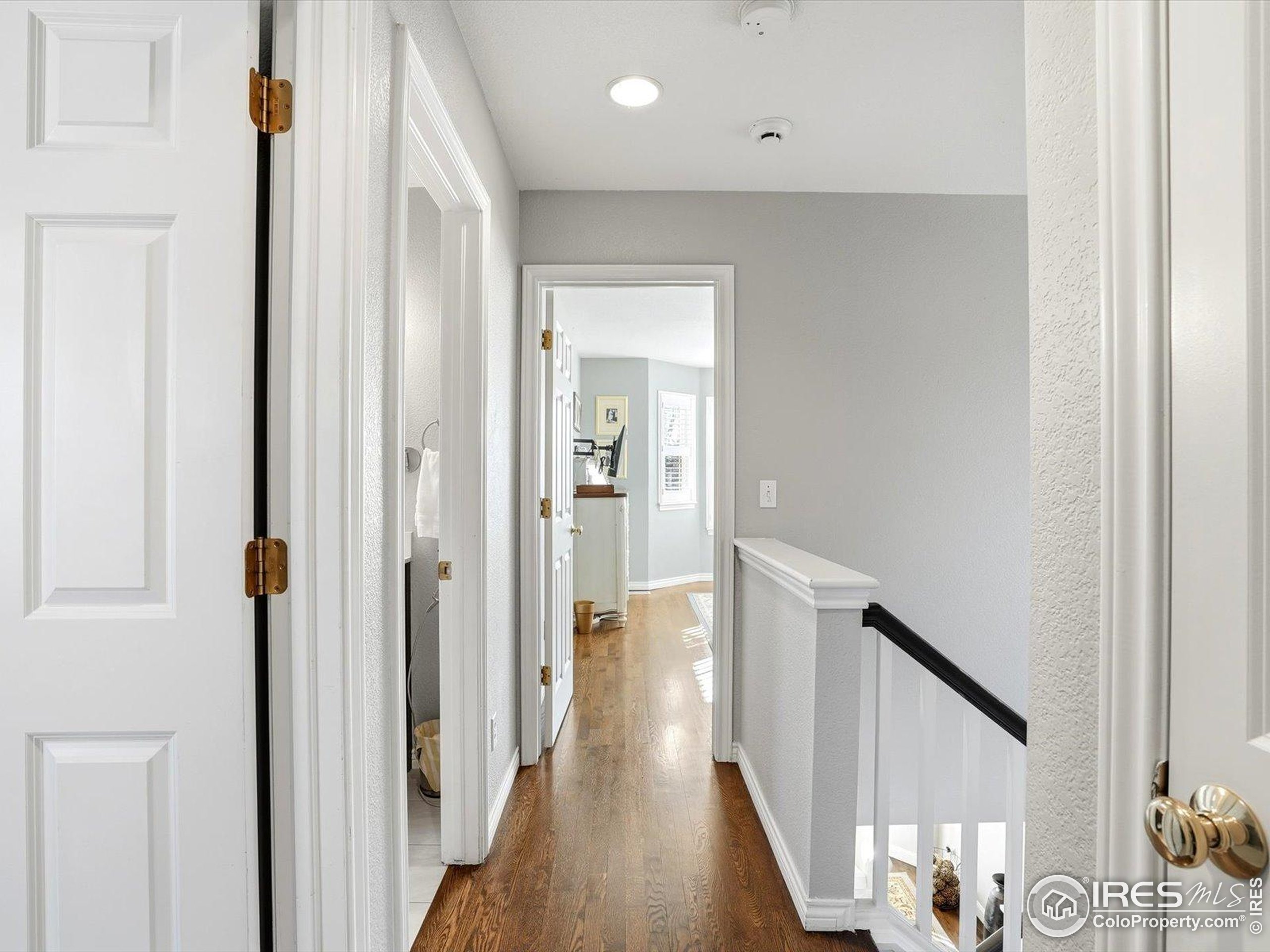 2139 Springs Place Longmont, CO 80504 - Photo 33 of 50 a view of hallway with wooden floor