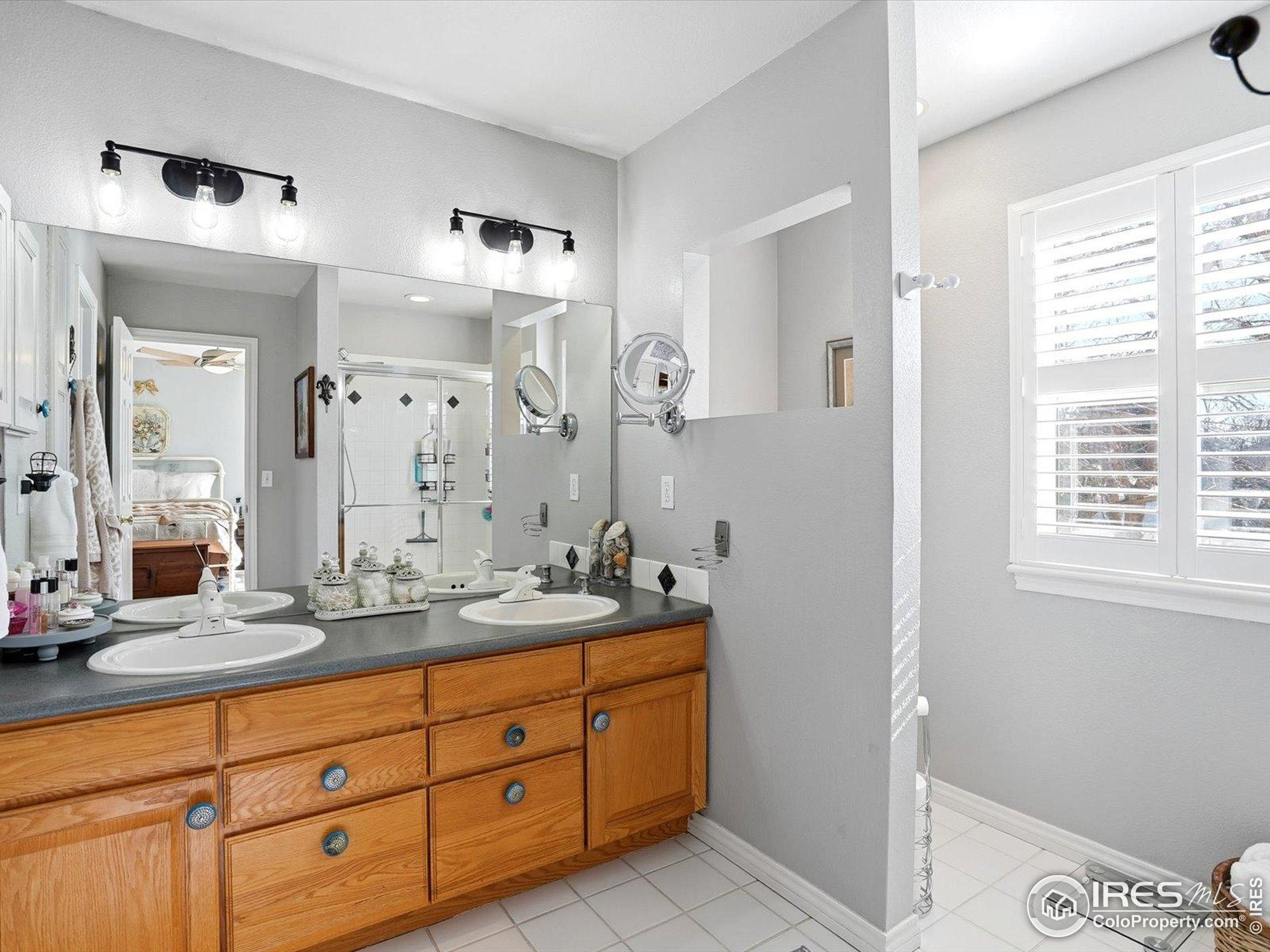 2139 Springs Place Longmont, CO 80504 - Photo 40 of 50 a spacious bathroom with double vanity and a mirror