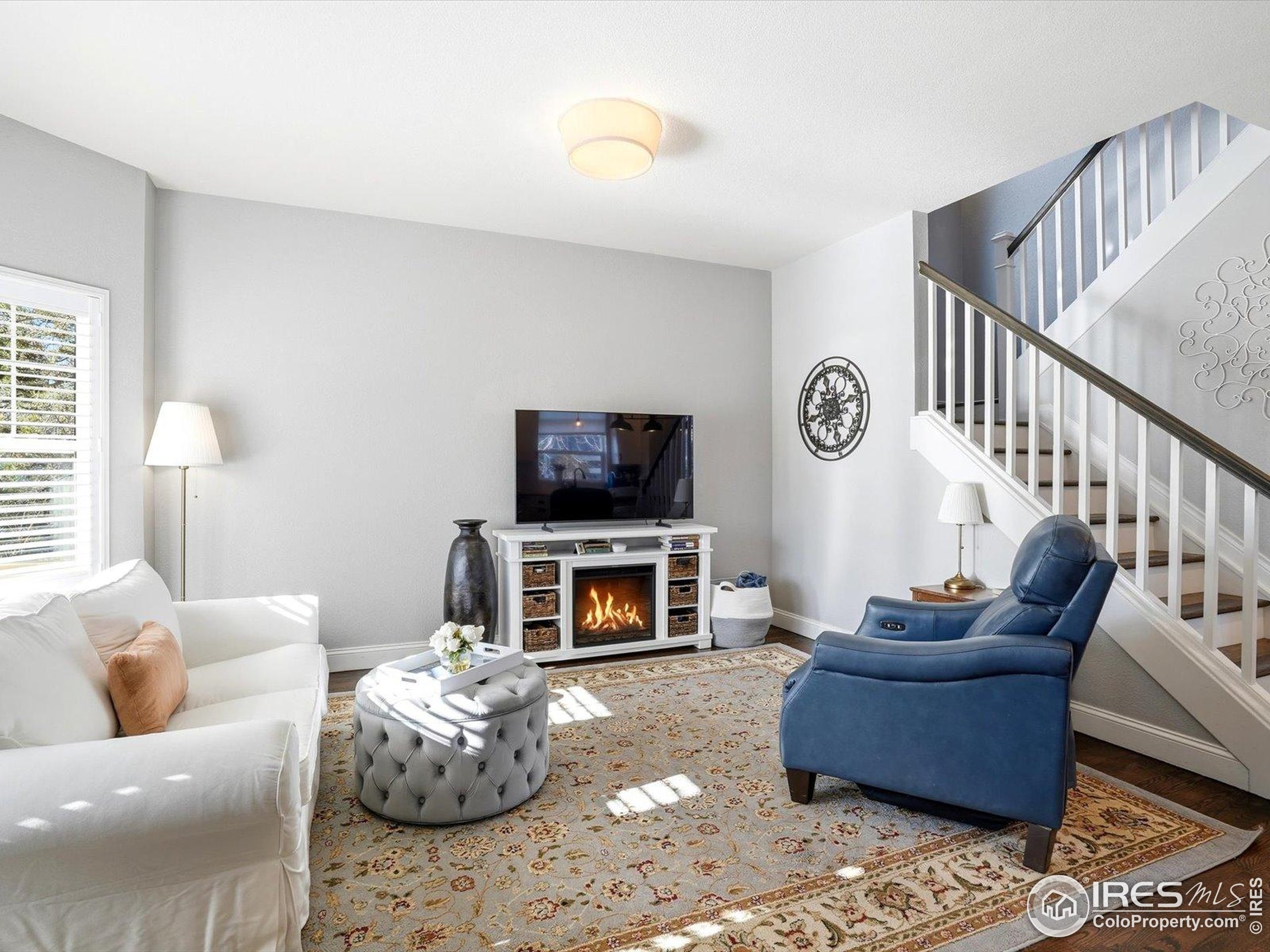 2139 Springs Place Longmont, CO 80504 - Photo 9 of 50 a living room with furniture flat screen tv and a fireplace