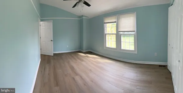 a view of a room with wooden floor staircase and a living room