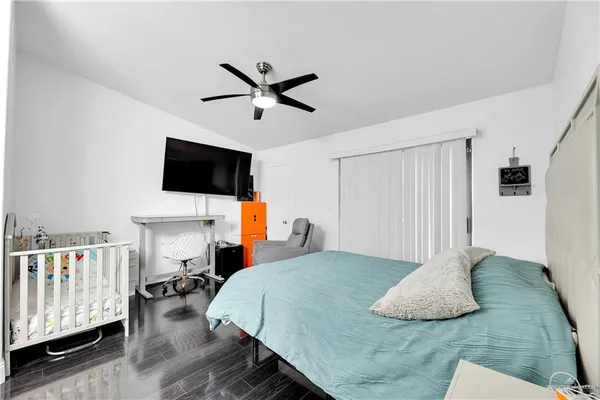 a bedroom with a bed and flat screen tv