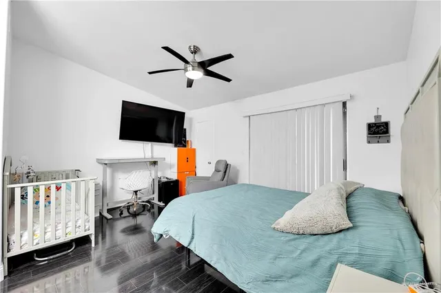 a bedroom with a bed and flat screen tv