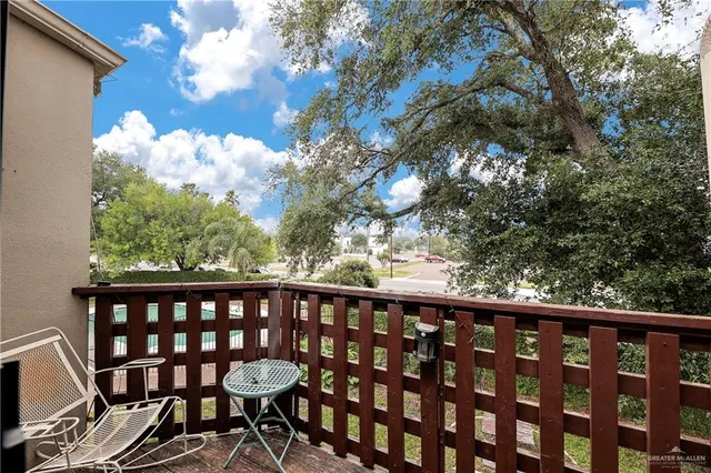 a view of a balcony with wooden floor