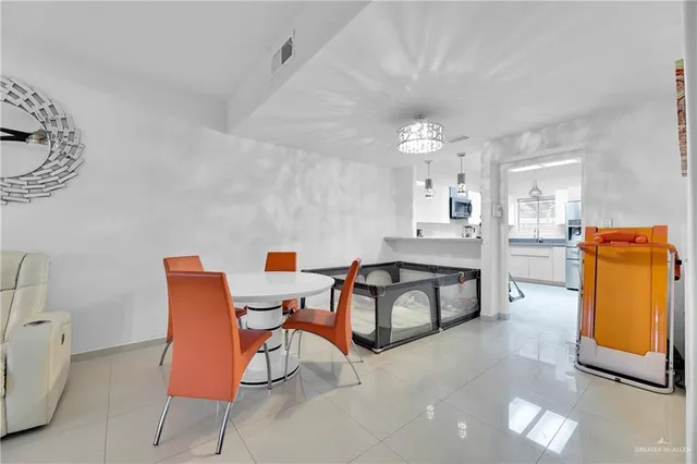 a living room with furniture and kitchen view