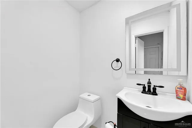 a bathroom with a toilet a sink and a mirror