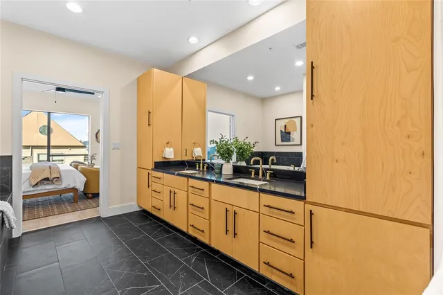 a large bathroom with a double vanity sink and mirror