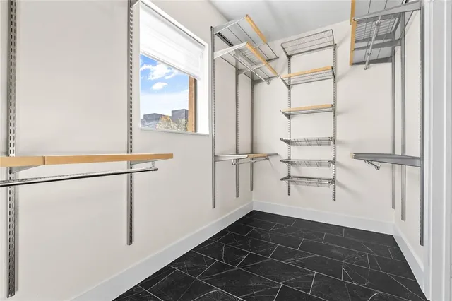 a view of walk in closet with empty racks