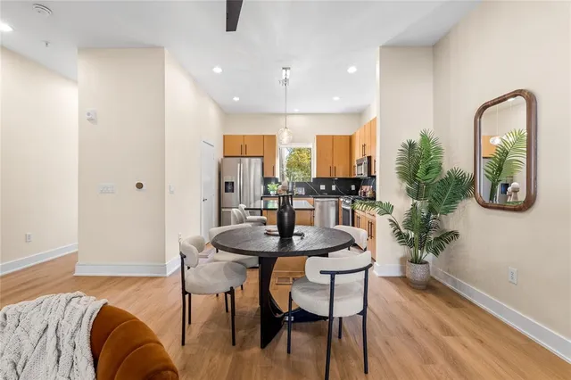 a view of a a dining room with furniture window and wooden floor