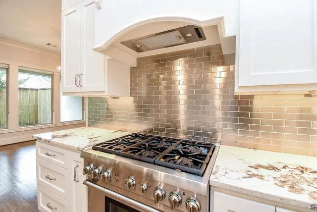 a stove top oven sitting inside of a kitchen