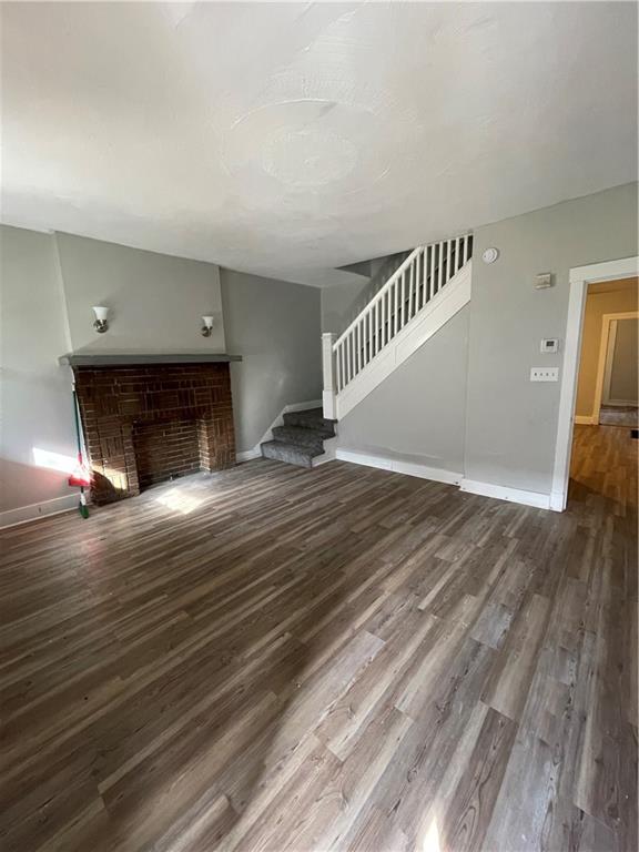 708 Webster Terrace Pittsburgh, PA 15219 - Photo 3 of 22 a view of empty room with wooden floor and fireplace