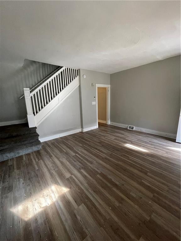 708 Webster Terrace Pittsburgh, PA 15219 - Photo 8 of 22 a view of an empty room with wooden floor and windows