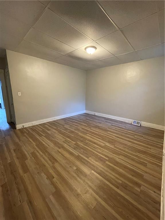 708 Webster Terrace Pittsburgh, PA 15219 - Photo 9 of 22 an empty room with wooden floor and windows