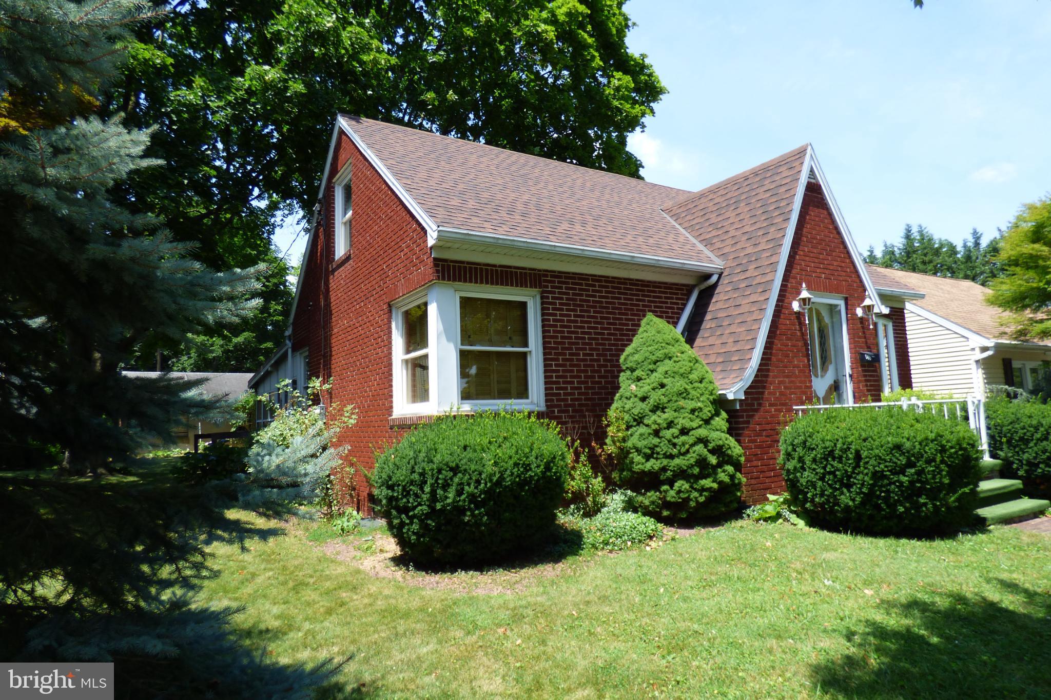 430 Moul Avenue Hanover, PA 17331 - Photo 2 of 30 Charming brick home with lush greenery.