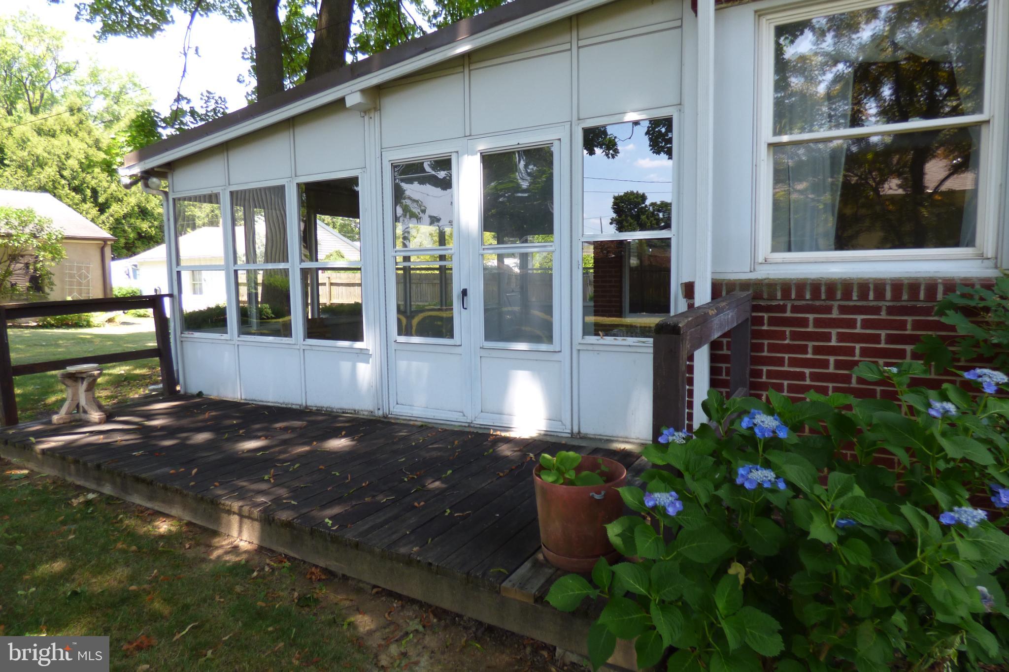 430 Moul Avenue Hanover, PA 17331 - Photo 29 of 30 Charming sunlit porch with lush greenery.