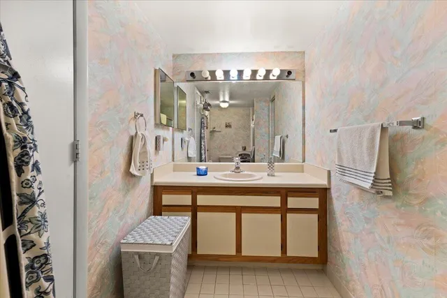 a bathroom with a sink a toilet and mirror