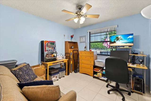 a work room with furniture and a flat screen tv