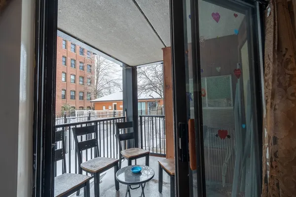 a view of a porch with a table and chairs
