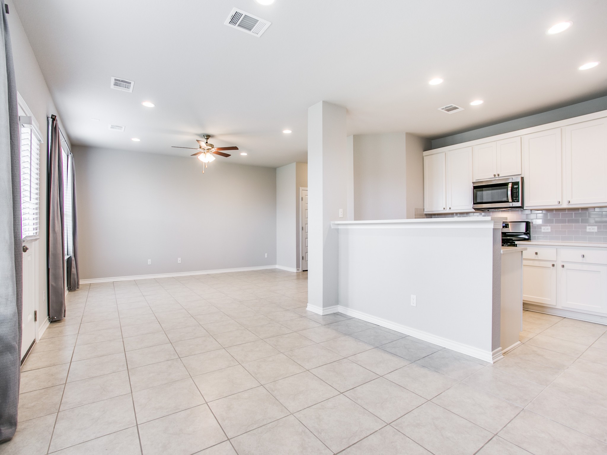 508 Rearing Mare Pass Georgetown, TX 78626 - Photo 4 of 26 Kitchen featuring appliances with stainless steel finishes, recessed lighting, tasteful backsplash, white cabinets, and ceiling fan