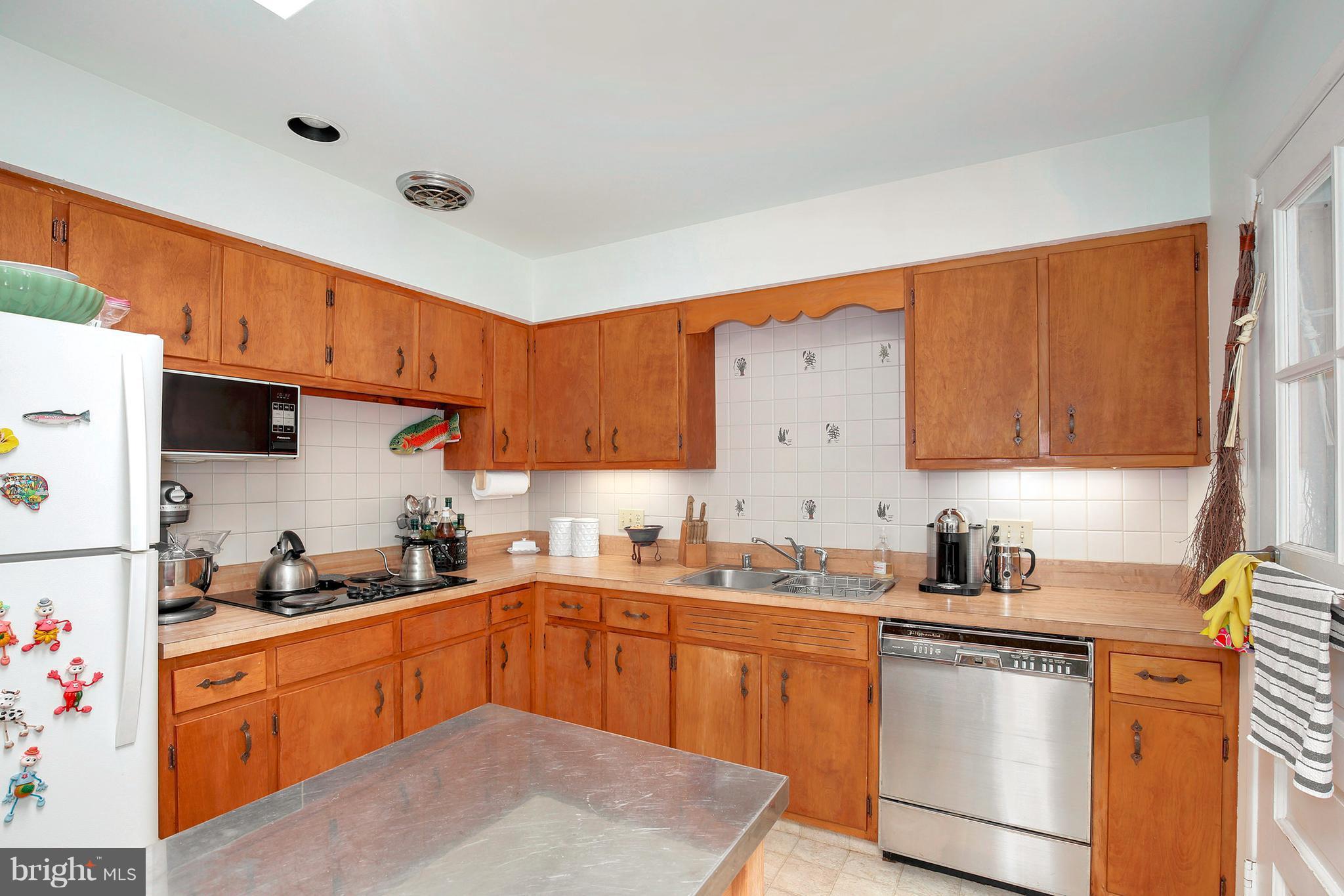 5304 Ravensworth Road Springfield, VA 22151 - Photo 11 of 30 a kitchen with stainless steel appliances a sink a stove a refrigerator cabinets and a window