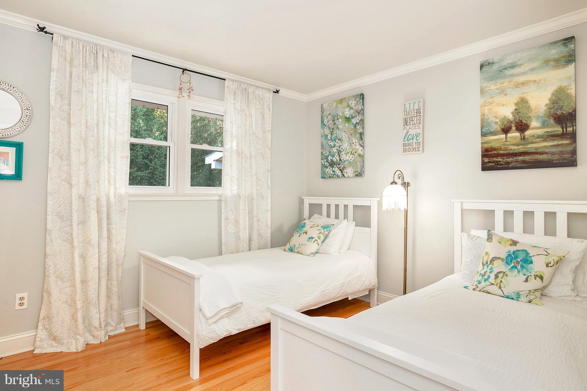 5304 Ravensworth Road Springfield, VA 22151 - Photo 19 of 30 a bedroom with a bed and wooden floor