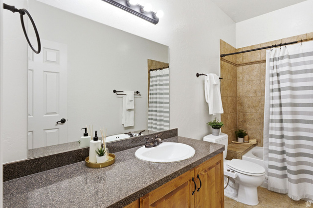 1712 Somerset Ridge Drive Draper, UT 84020 - Photo 53 of 76 Full bathroom featuring a wood-finish vanity with a speckled countertop, a large integrated mirror, and a ceramic sink