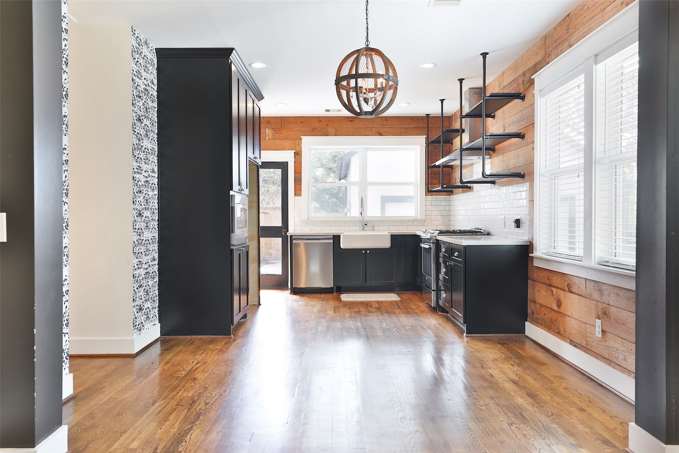 126 2nd Street Sugar Land, TX 77498 - Photo 12 of 50 a view of a kitchen with wooden floor and stainless steel appliances