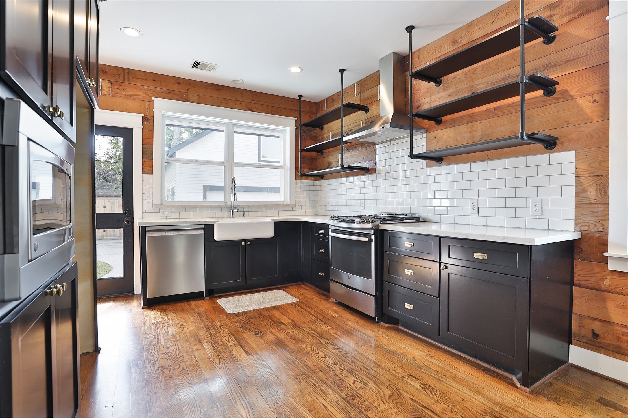 126 2nd Street Sugar Land, TX 77498 - Photo 15 of 50 a kitchen with stainless steel appliances granite countertop a stove a sink and a refrigerator