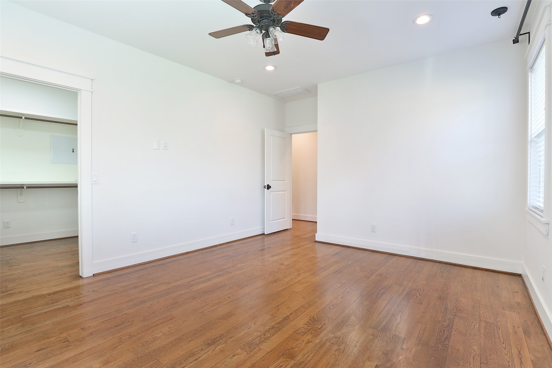 126 2nd Street Sugar Land, TX 77498 - Photo 30 of 50 an empty room with wooden floor chandelier fan and windows